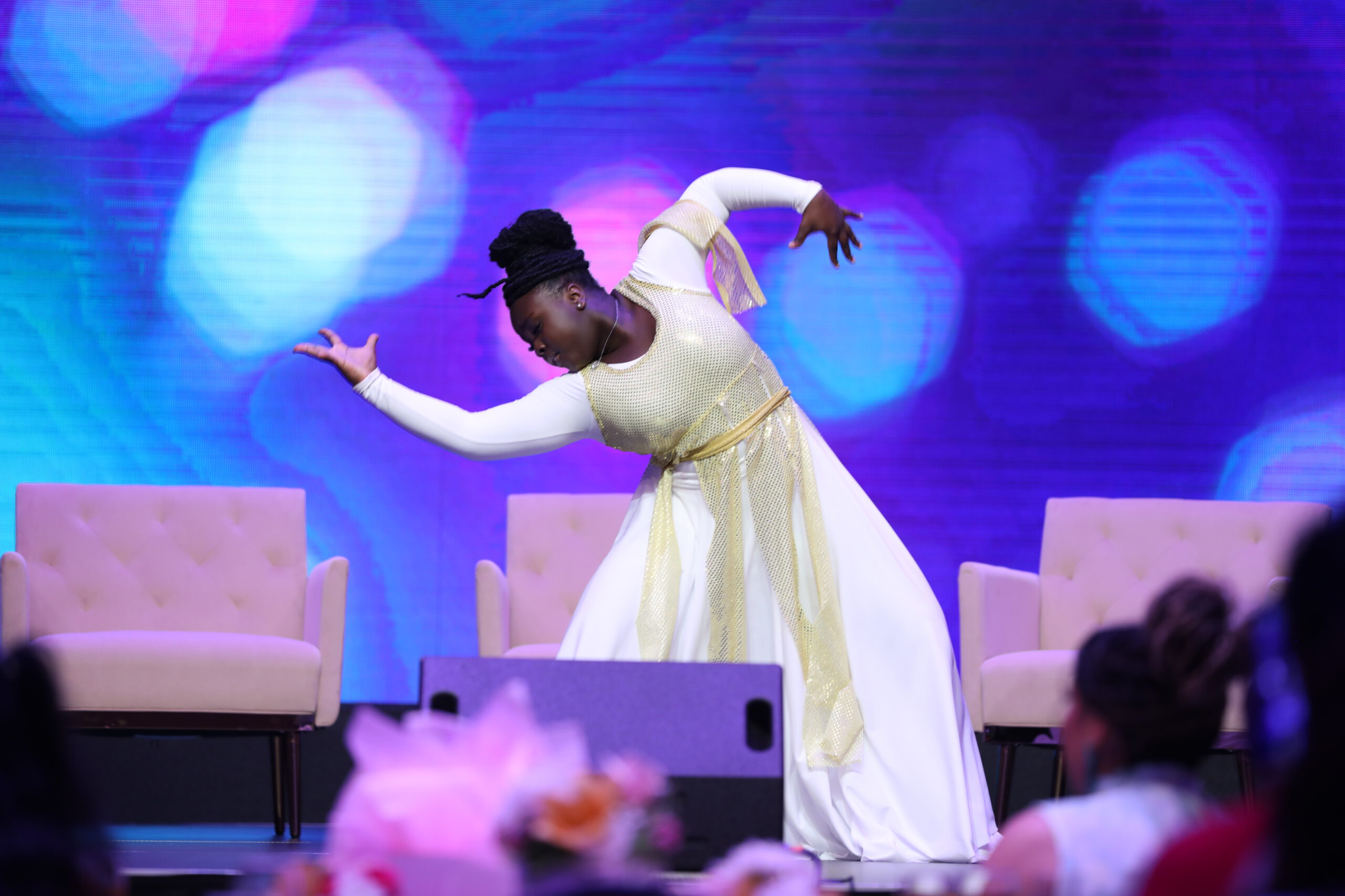 Young woman dancing on stage.